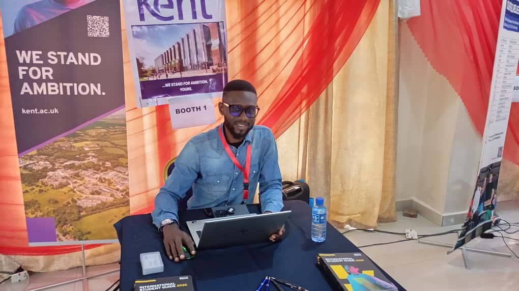 University representative at an education fair booth