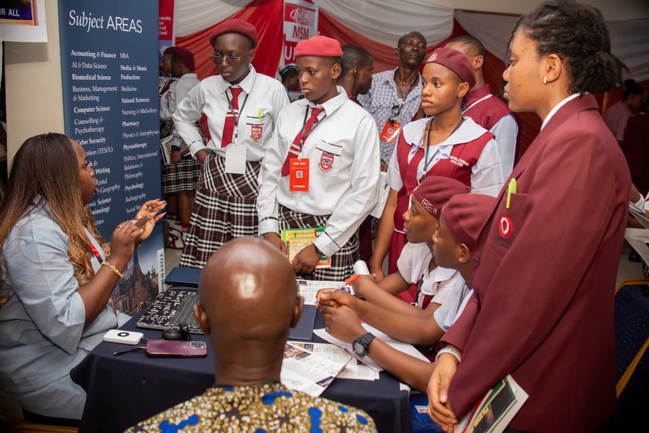 Students speaking with representatives at an international education booth